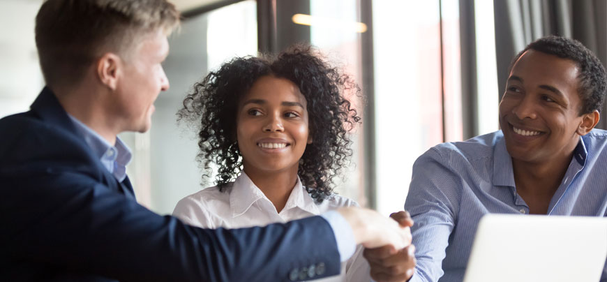 Individuals shaking hands during meeting