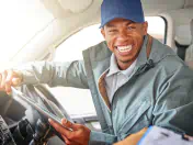 Smiling truck driver looks out the cabin window