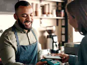 Cafe worker accepts an electronic payment